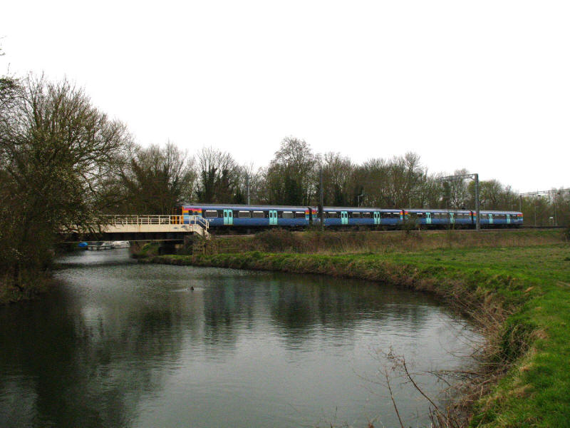 Roydon station and One Railway train over River Stort