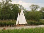 A boat sails up the Waveney during a walk on the Angles Way from Beccles to Oulton Broad in Lowestoft